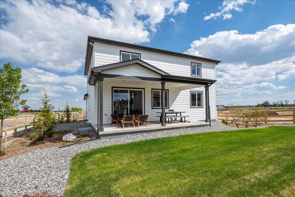 A house with a lawn and a fence.