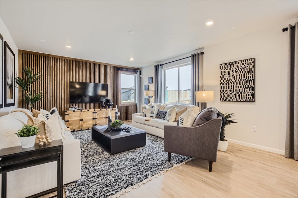 A living room with a large tv and couches.