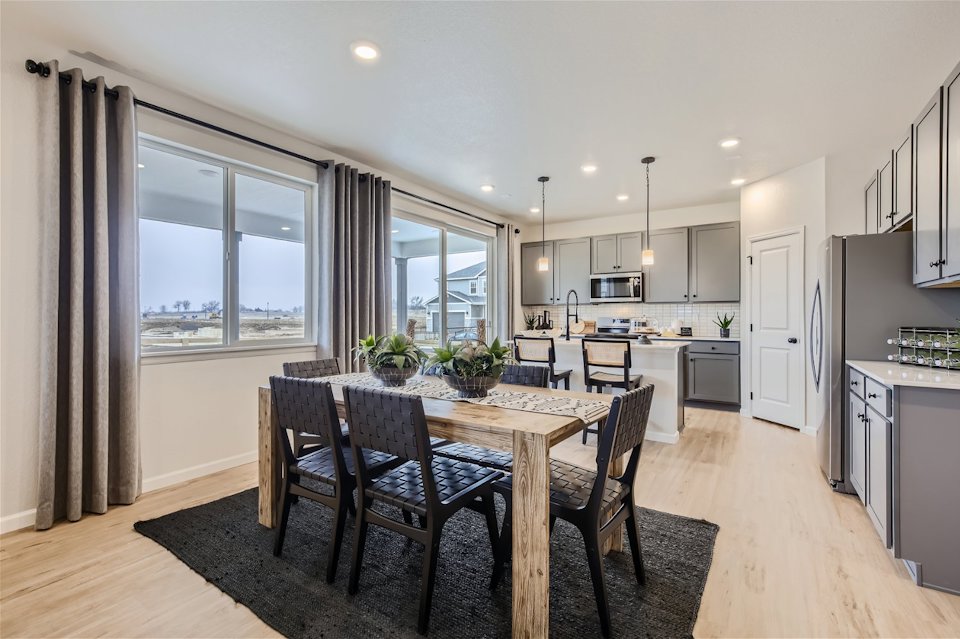 A kitchen with a dining table.