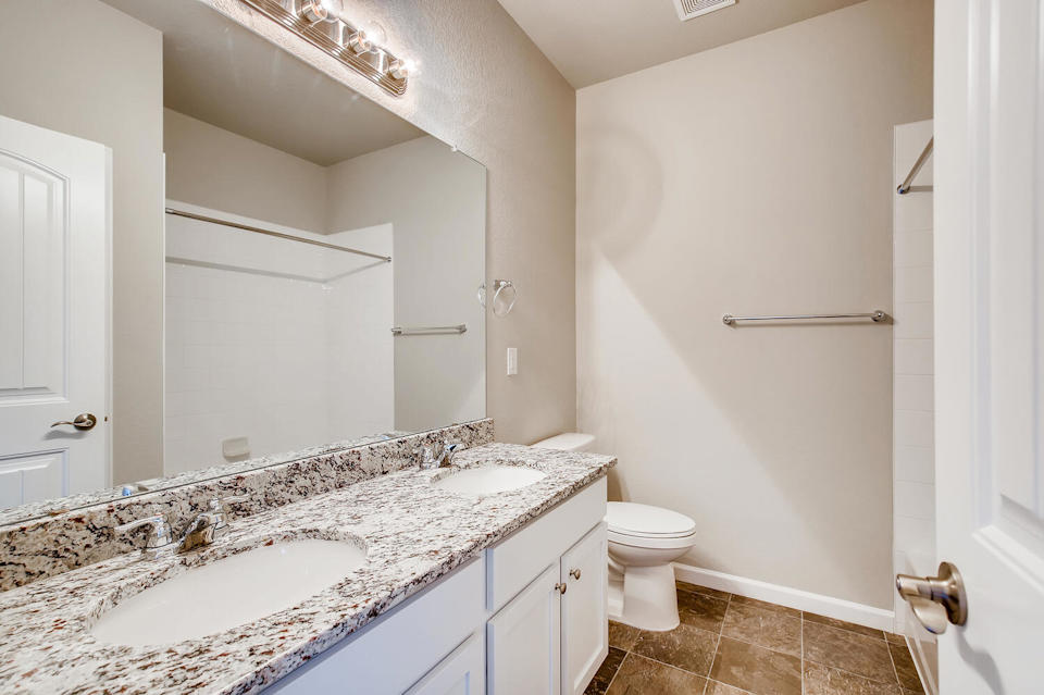 A bathroom with a marble countertop.