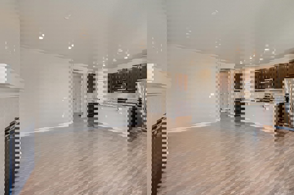 A large kitchen with wooden floors.