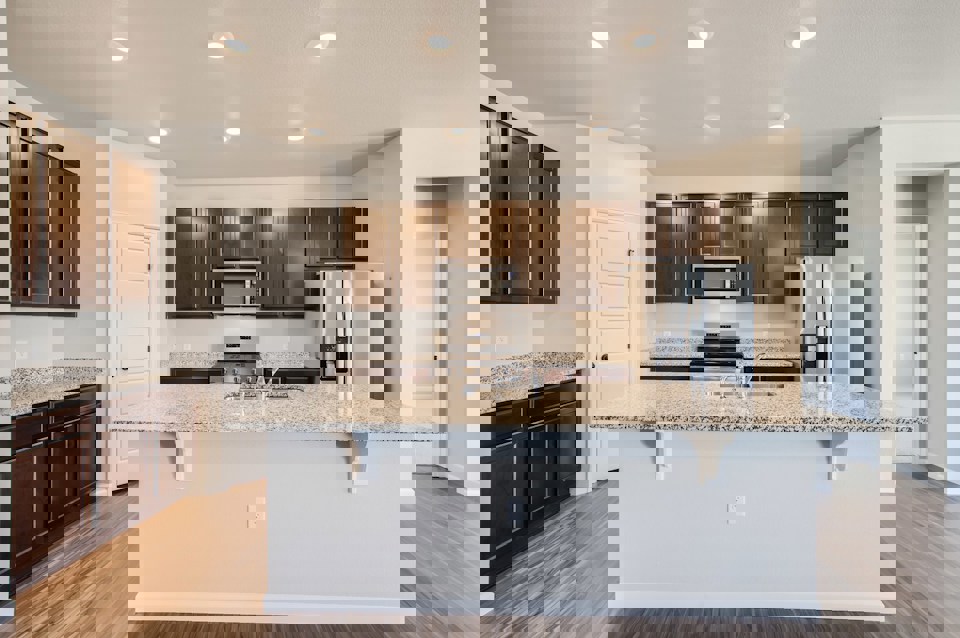 A kitchen with a marble counter top.