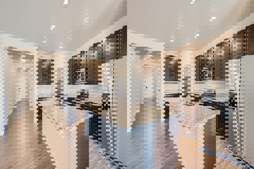 A kitchen with a marble counter top.