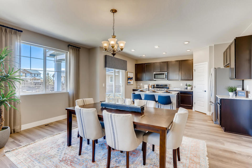 A large kitchen with a dining table.
