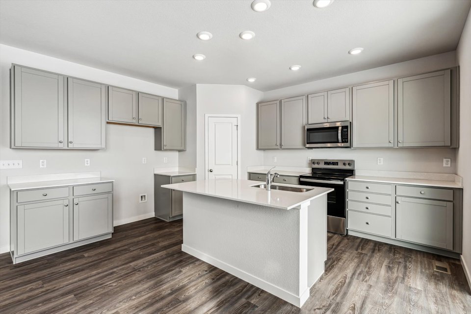 A kitchen with white cabinets.