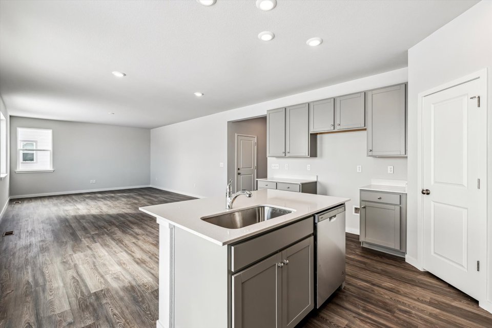 A kitchen with white cabinets.