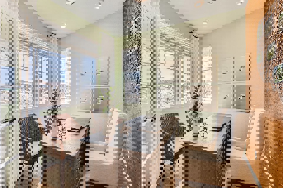 A kitchen with a table and chairs.