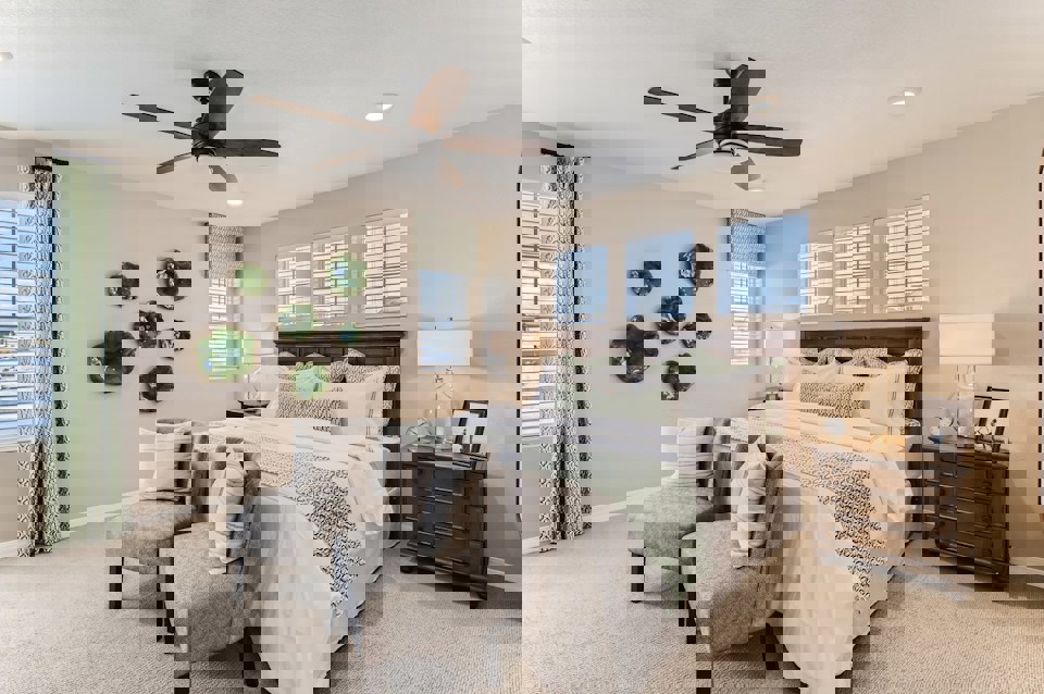 A bedroom with a bed and a fan.