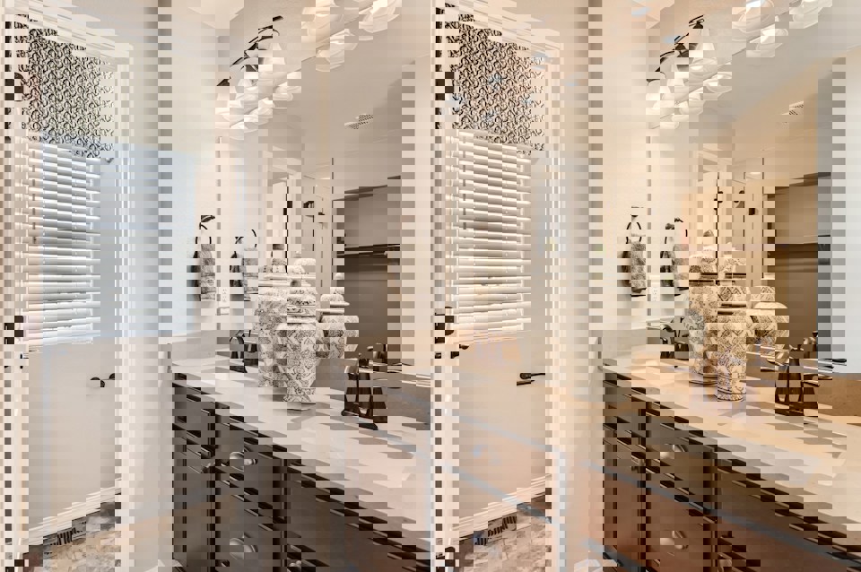 A bathroom with a large mirror.