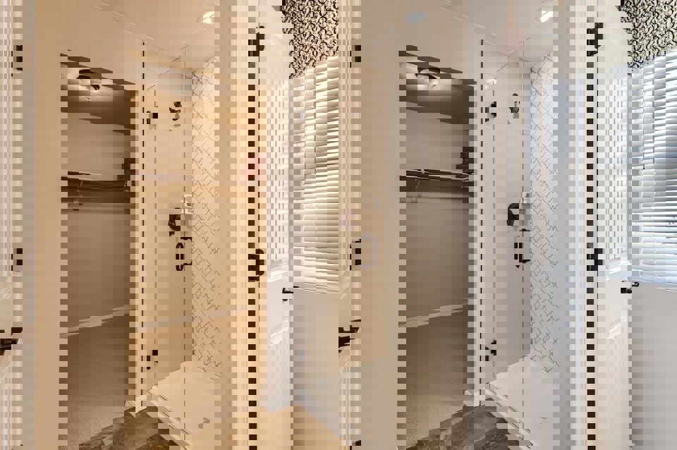 A bathroom with a shower unit and a bathtub.