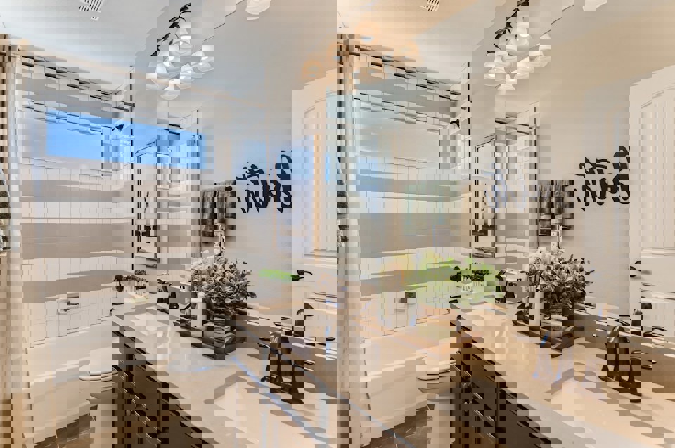 A bathroom with a tub sink and a toilet.