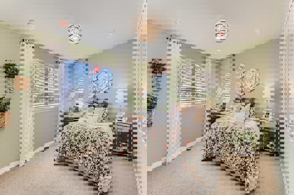 A bedroom with a bed and lamps.