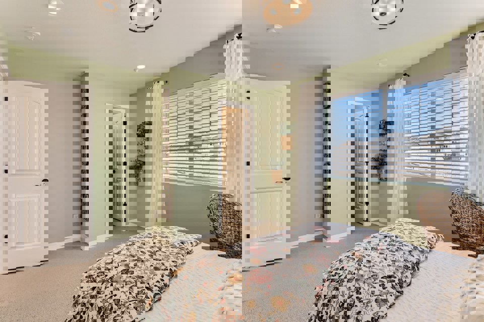 A bedroom with a bed and a window.