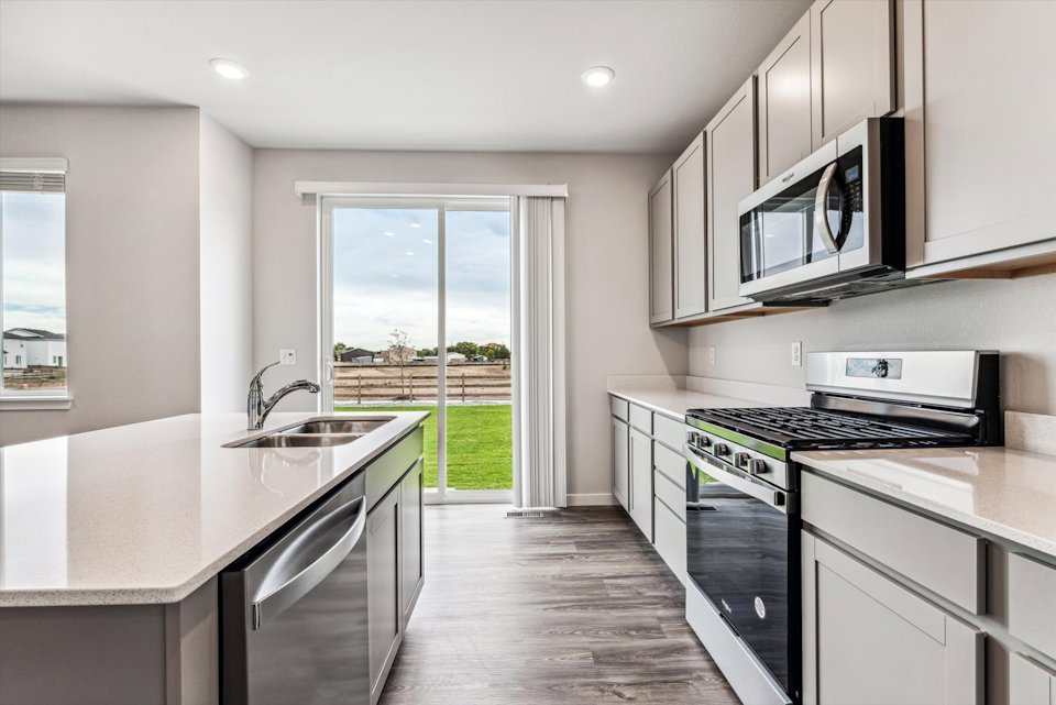 A kitchen with black appliances.