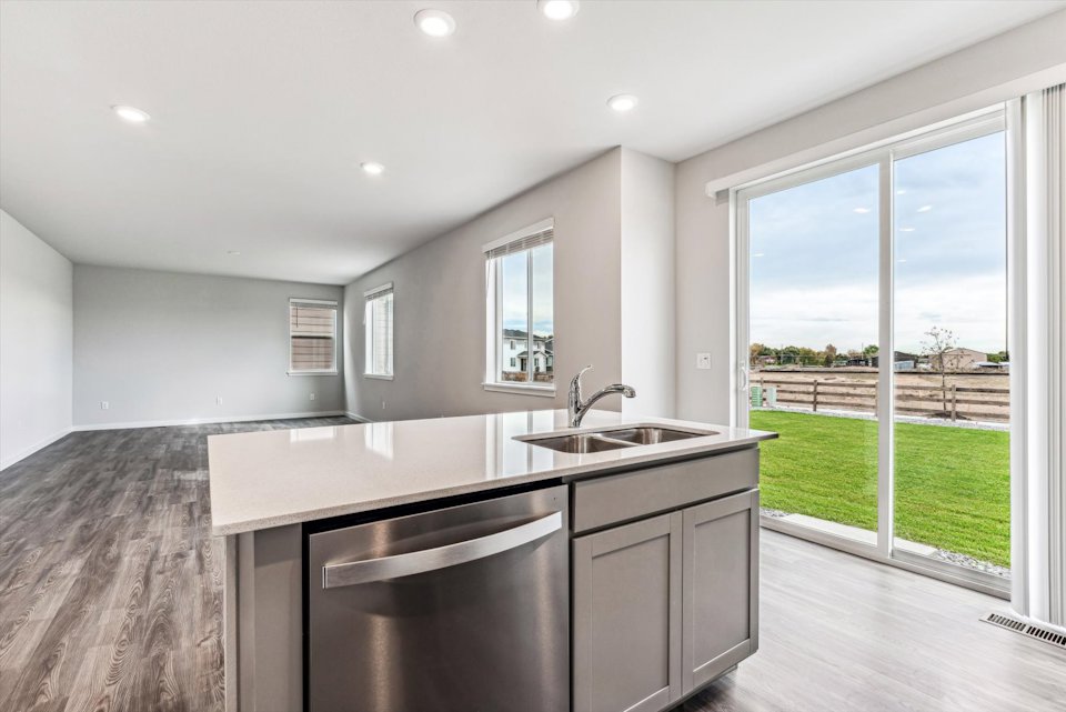 A kitchen with a large window.