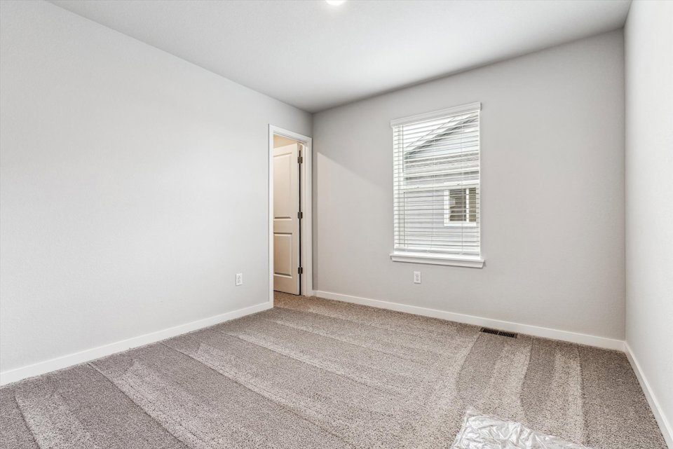 A room with a door and a rug.