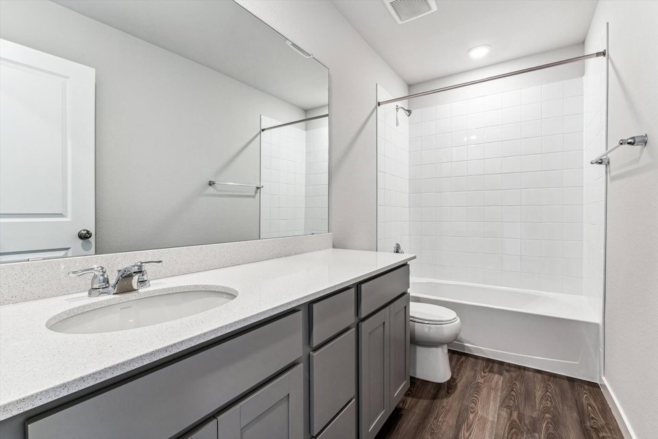 A bathroom with a sink toilet and shower.