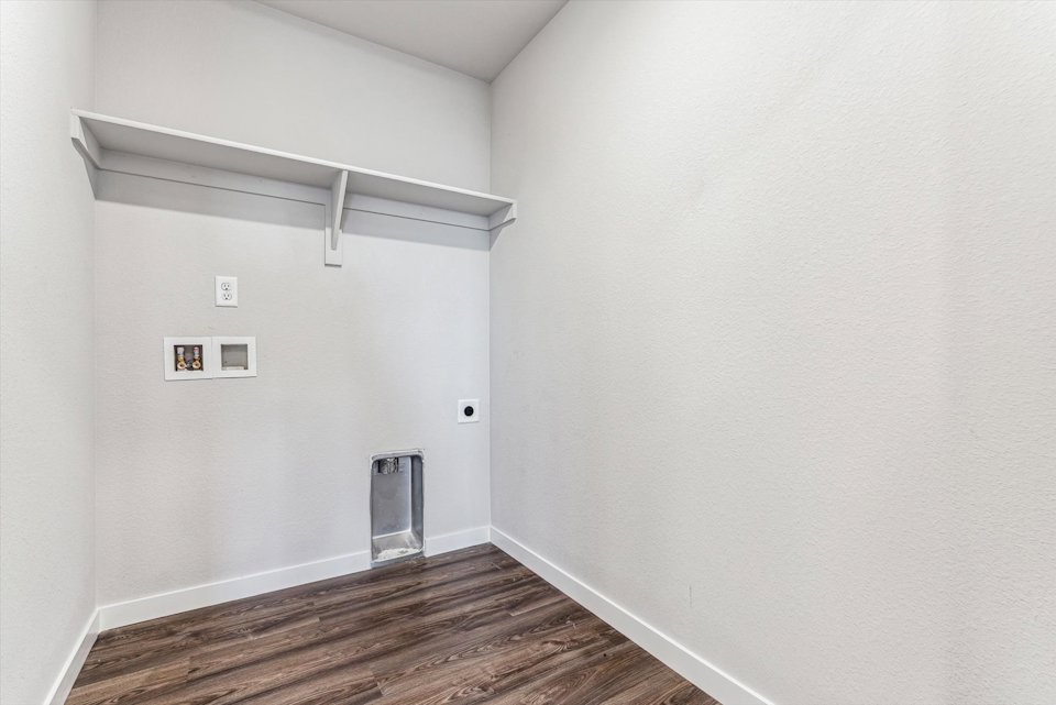 A white room with a wood floor.
