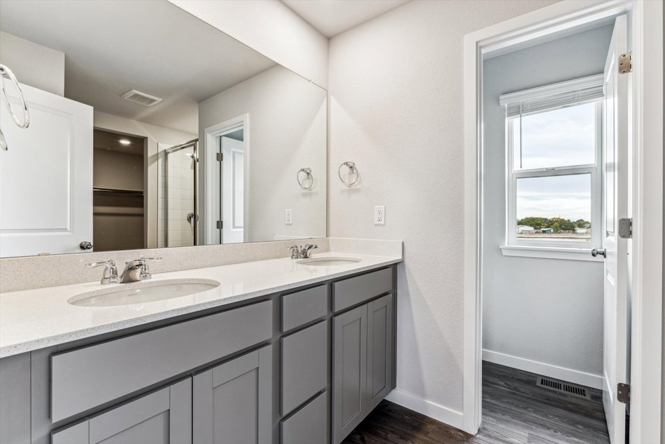 A bathroom with a large mirror.