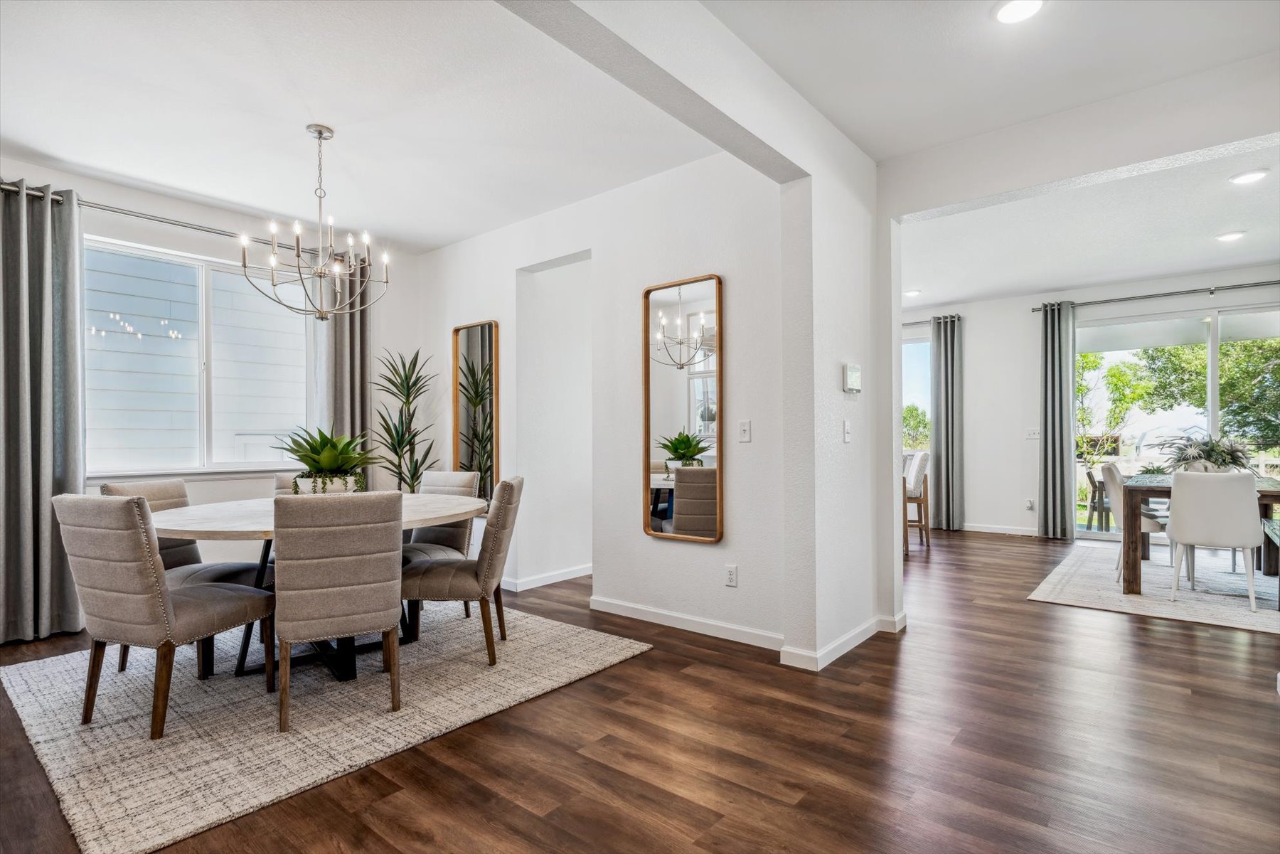 A dining room with a wood floor.