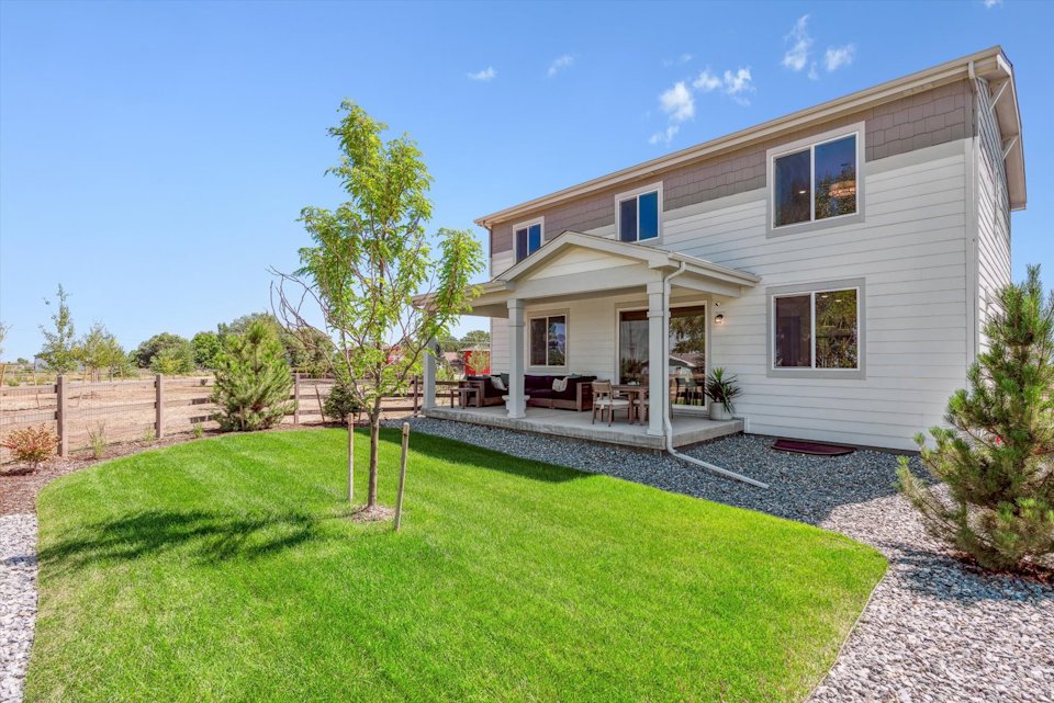 A house with a yard and a fence.