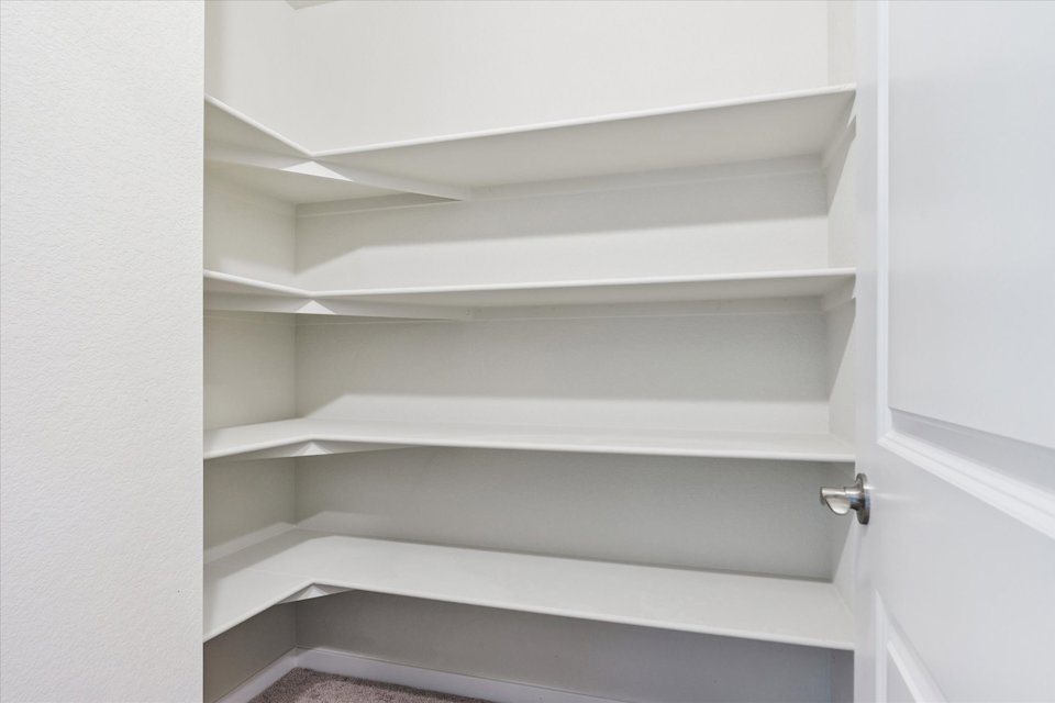 A white shelf with a door.