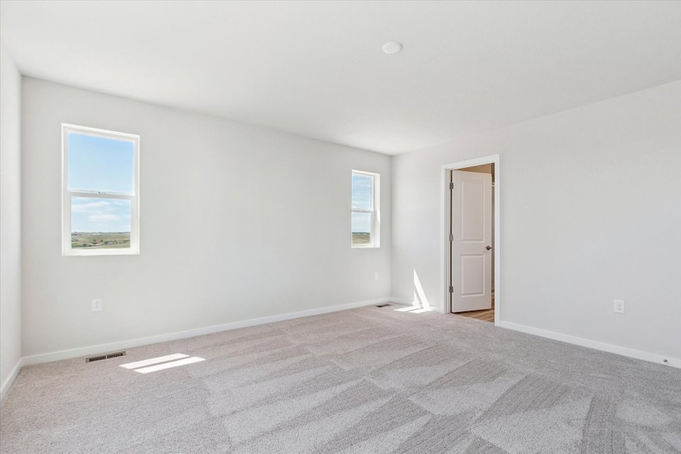 A room with a bed and a door.