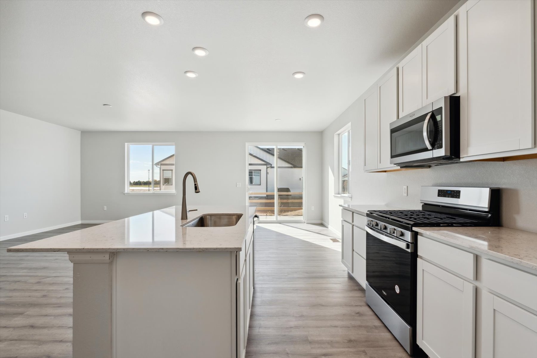 A kitchen with white cabinets.