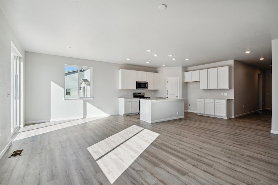 A large kitchen with white cabinets.