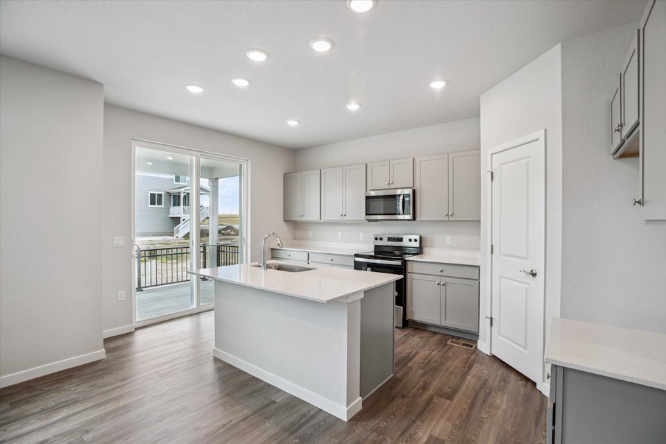A kitchen with white cabinets.