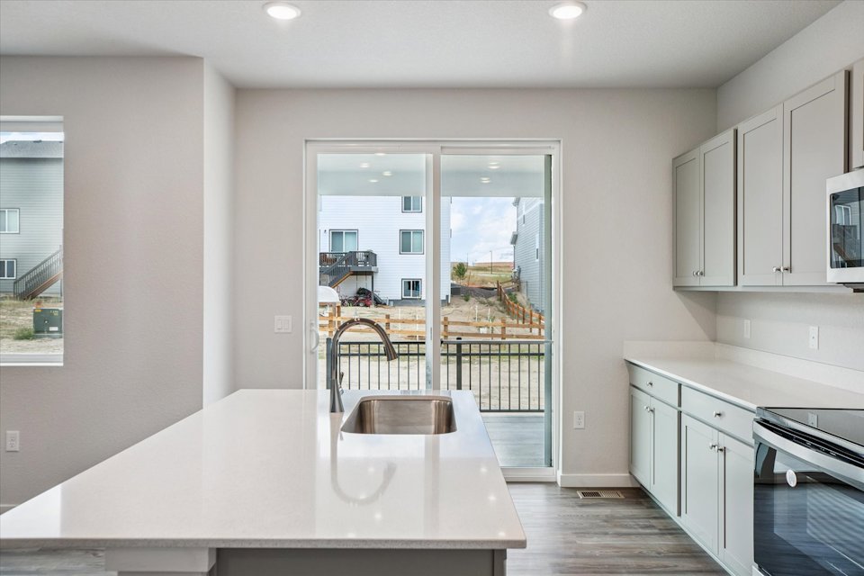 A kitchen with a table and chairs.