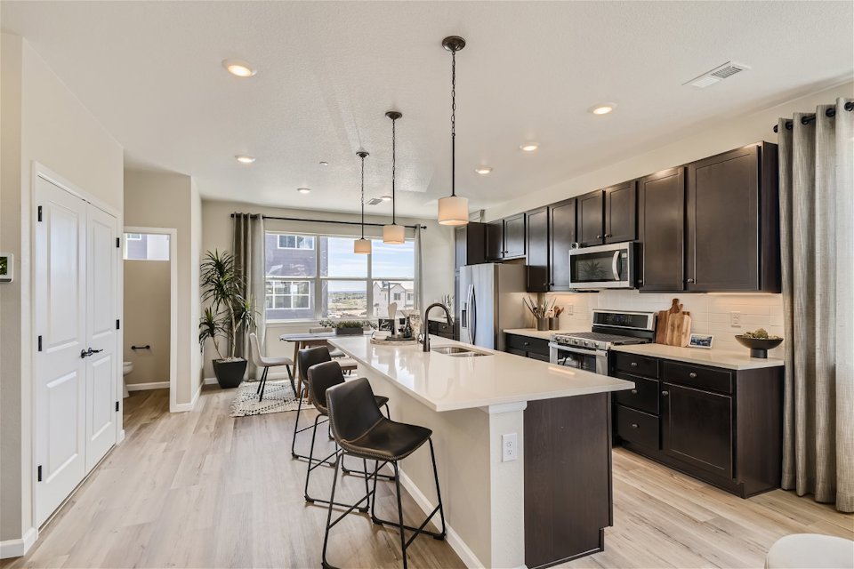 A kitchen with black cabinets.