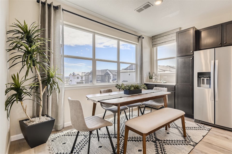 A kitchen with a table and chairs.