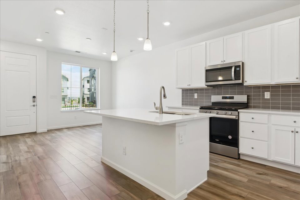 A kitchen with white cabinets.