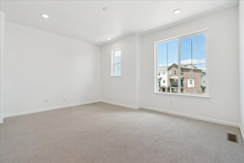 A room with a window and a carpet.