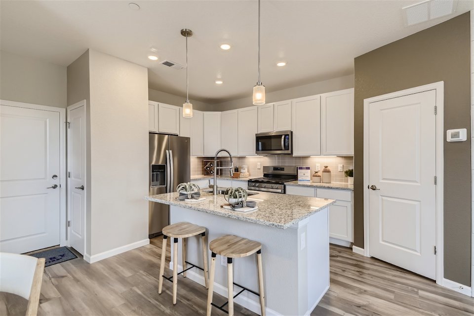 A kitchen with white cabinets.