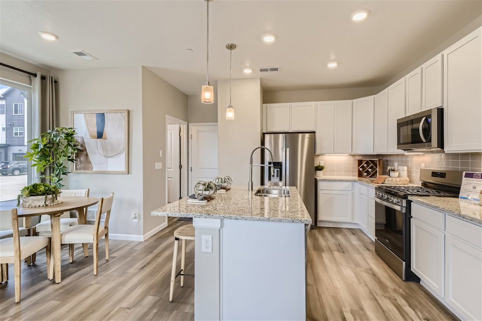 A kitchen with white cabinets.