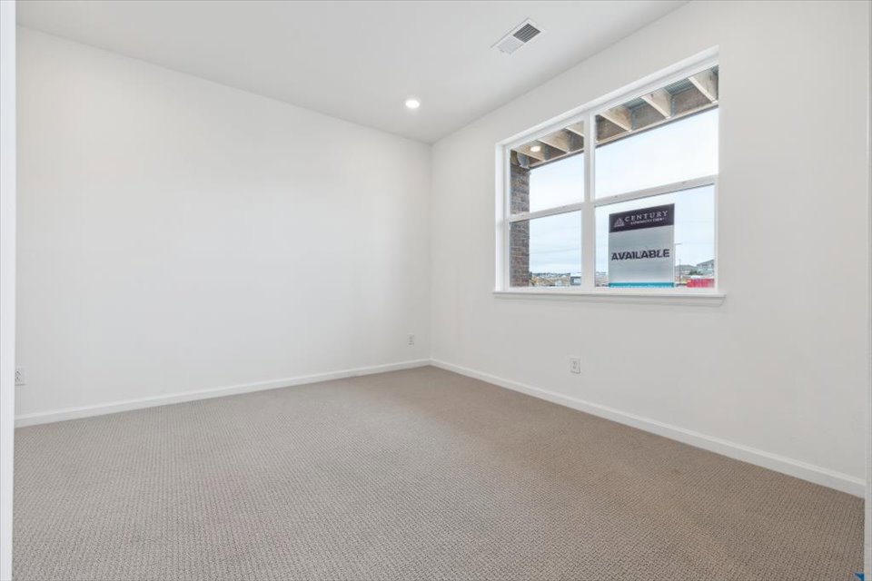 A room with a window and a carpet.