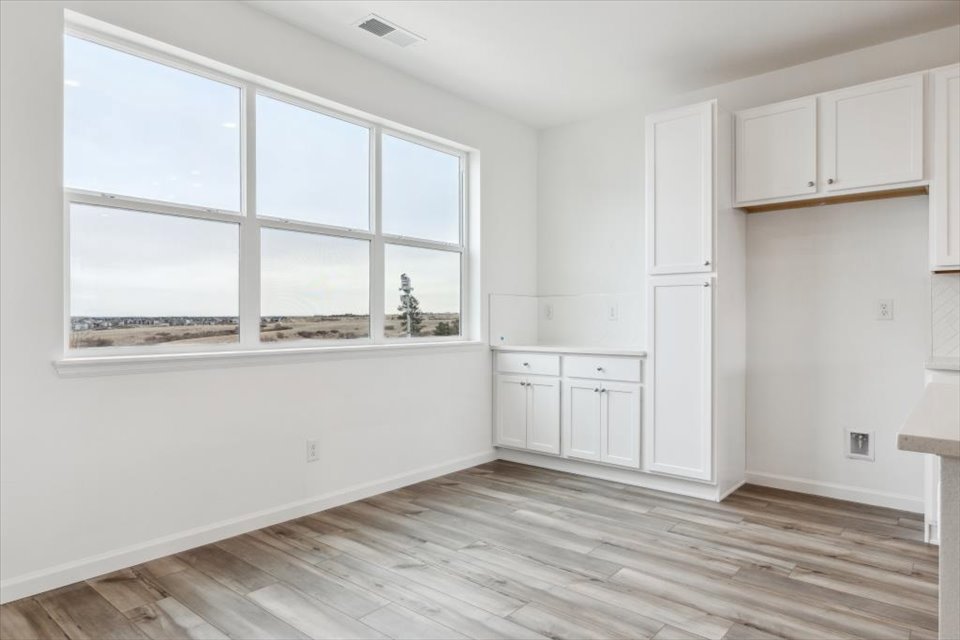 A room with white cabinets.