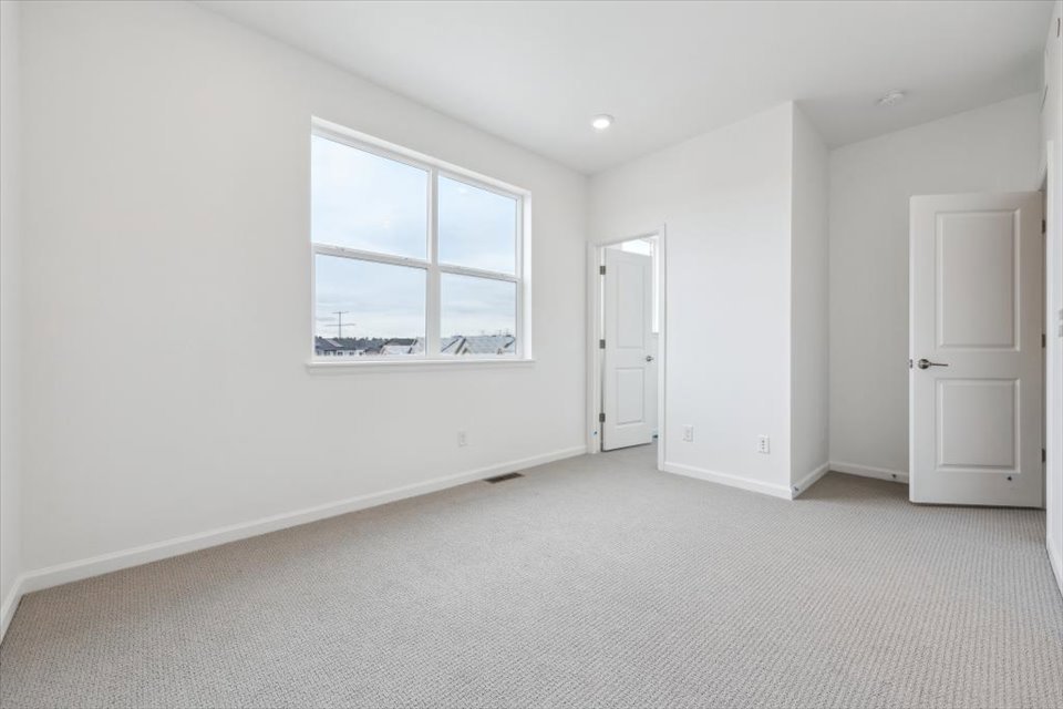 A room with white walls and a window.