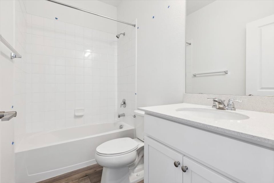 A bathroom with a tub sink and toilet.