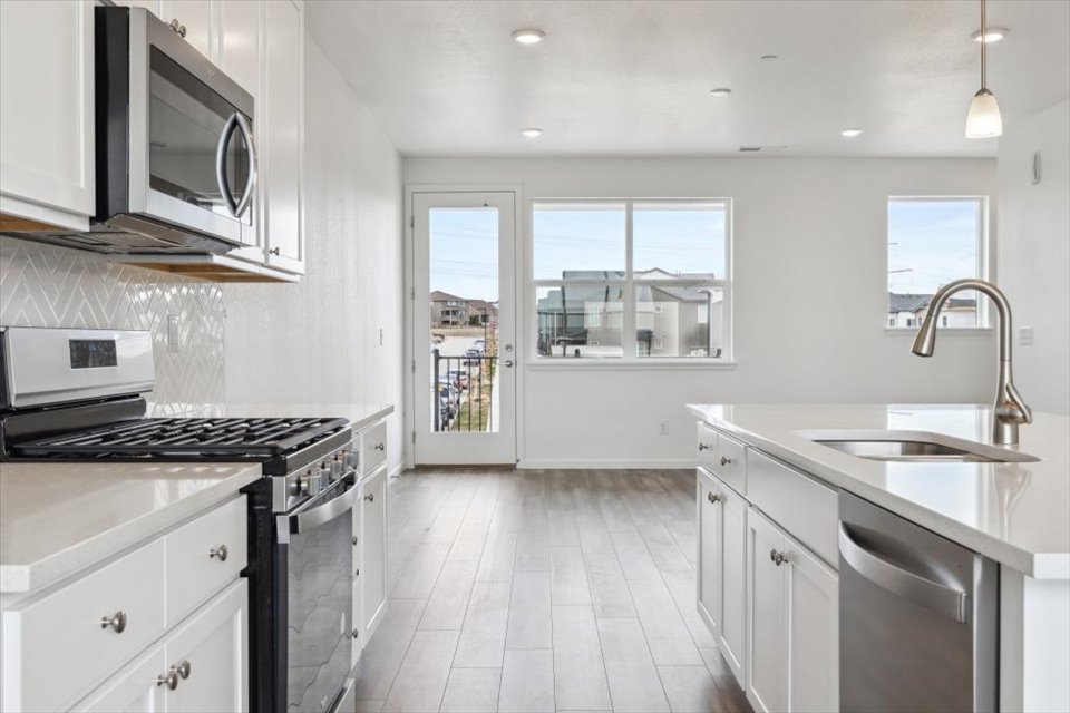 A kitchen with white cabinets.