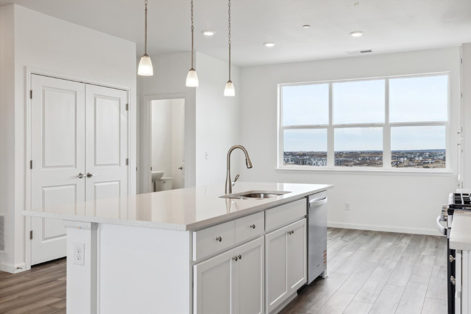 A kitchen with white cabinets.