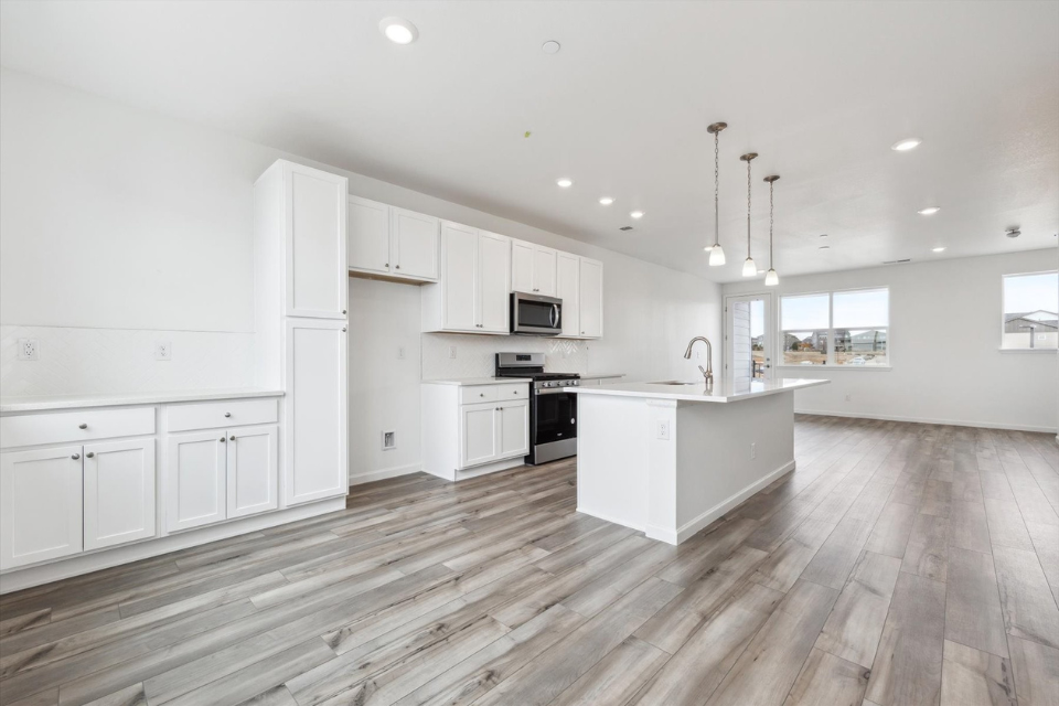 A kitchen with white cabinets.
