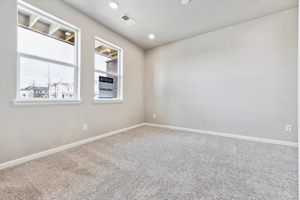 A room with a white wall and a window.