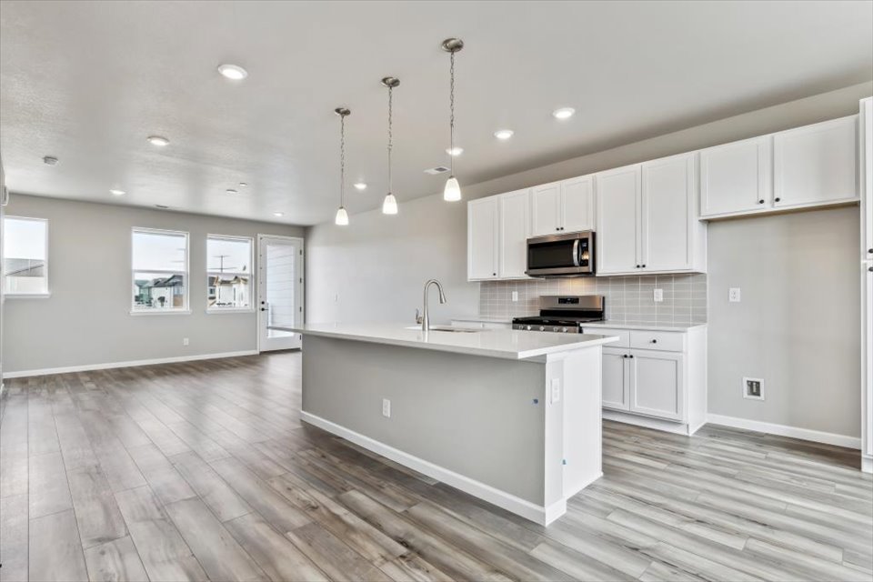 A kitchen with white cabinets.