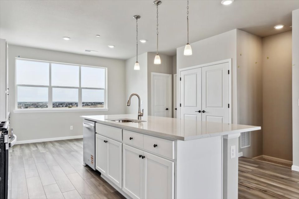 A kitchen with white cabinets.