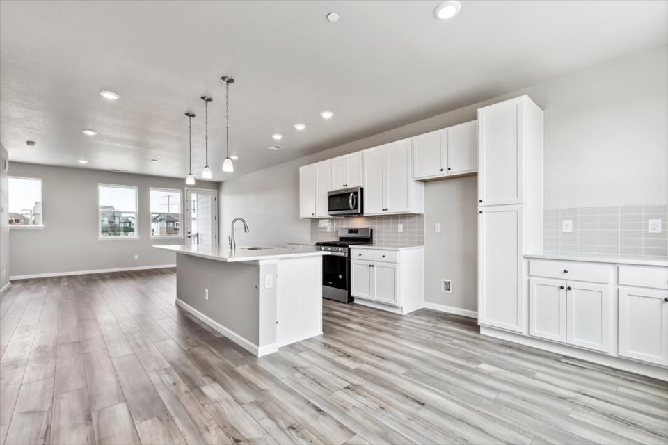 A kitchen with white cabinets.