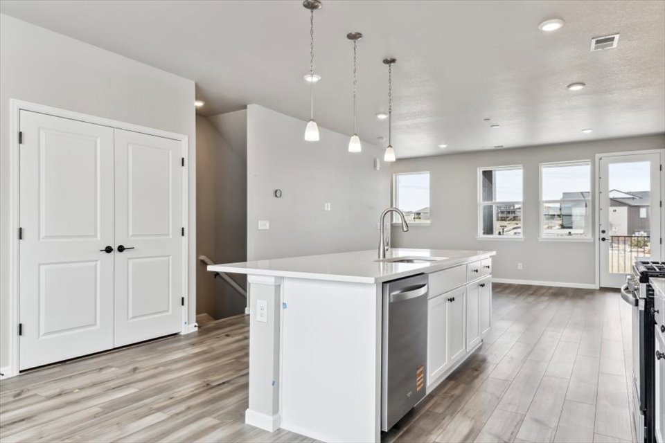A kitchen with white cabinets.