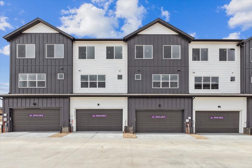 A grey building with garages.
